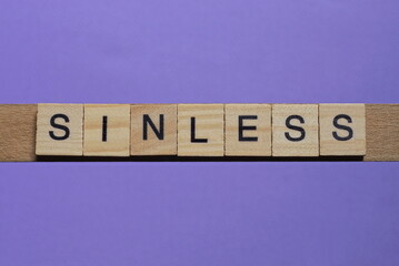 word sinless made from wooden gray letters lies on a lilac background
