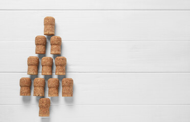 Christmas tree made of wine corks on white wooden table, top view. Space for text