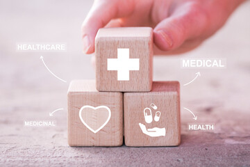Doctor hand arranging wood block stacking with healthcare icons concept, medical insurance for your health.