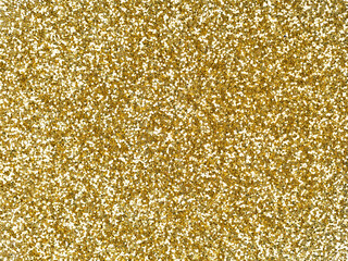 Gold glitter texture. Sparkling shiny background for Christmas holiday seasonal wallpaper...