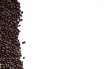 Coffee beans isolated on white background with space for text. Roasted coffee beans as background. Flat lay, top view, copy space