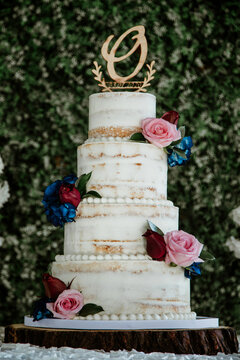 white wedding cake with flowers and green background