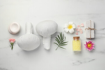 Flat lay composition with different spa products on white marble table