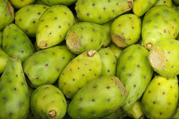 Delicious fresh ripe opuntia fruits as background, closeup