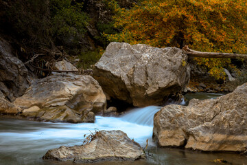 rocks in the river, fast flowing stream of rocks