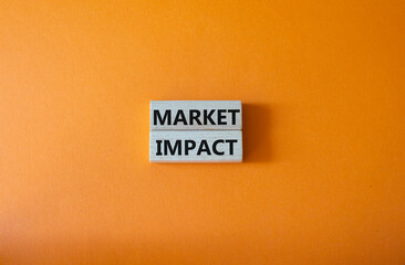 Market impact. Concept word Market impact on wooden cubes. Beautiful orange background. Business and Market impact concept. Copy space.