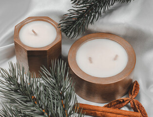 Decorative candles in a pot and fir branches, festive composition, selective focus