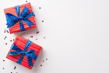 Forth of July celebration concept. Top view photo of red gift boxes with blue ribbon bows and star...