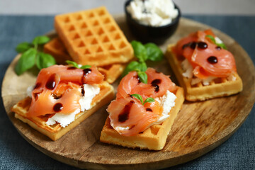 Salmon sandwich on Viennese waffles with ricotta cheese. Delicious waffles with salmon and cream cheese.