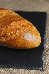 Delicious fresh rye round bread on a dark background. Crispy fresh bread. Freshly baked bread