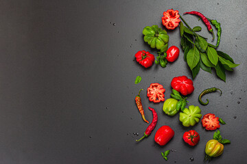 Green and red ribbed tomatoes, American or Florentine variety. Ripe vegetables, fresh bay leaves