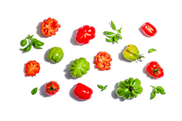 Green and red ribbed tomatoes isolated on white background. American or Florentine variety