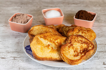 (Torrijas) Fried bread soaked in milk flavored with vanilla, cinnamon and lemon, and egg. Typical Easter sweet. Traditional and festive cuisine concept.