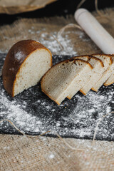 Slices of whole grain rye fresh bread on a dark background close up. Fresh home-baked sourdough bread