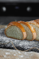 Slices of whole grain rye fresh bread on a dark background close up. Fresh home-baked sourdough bread