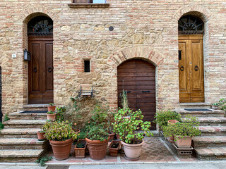 Pienza, Tuscany, Italy - 17.10.2022. Old house facade in Pienza, Tuscany, Italy. Beautiful Italian street of small old provincial town. Street view and facade of old house. Tuscany, Italy. Street view - obrazy, fototapety, plakaty