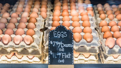 Eggs for sale on display for local business stall at farmer's market. Fresh brown chicken eggs...