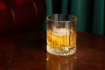 crystal glass of whiskey on a wooden table