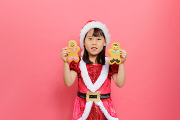 Merry Christmas! Young girl celebrating Christmas against pink background