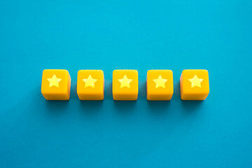 Five stars in a row on yellow blocks. Evaluation of the quality of the provided service. Feedback...