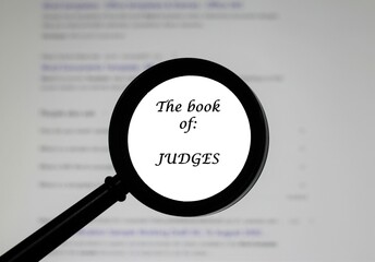  The Book of Judges from the Holy Bible, illustrated inside a magnifying class, zoomed in.