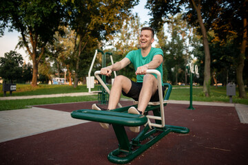 Guy training in outdoor gym