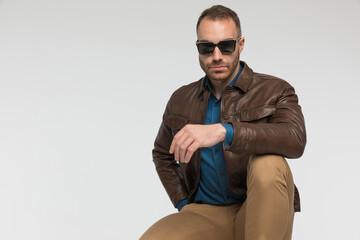 sexy casual man is squatting like a boss