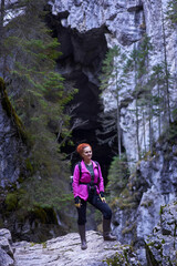 Naklejka na ściany i meble Woman hiking on a trail in the mountains