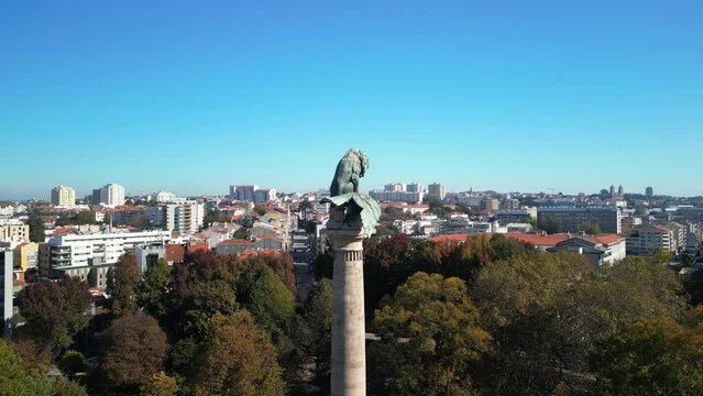 Aerial footage of the statue in a roundabout in Porto, Rotunda da Boavista