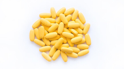 Close-up texture of yellow multivitamin tablets on white background. Healthy lifestyle concept
