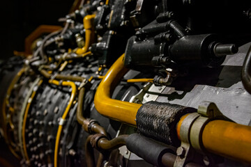 Yellow pipes in dark, black jet engine
