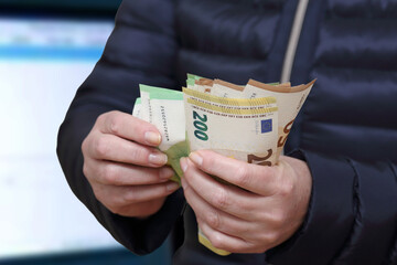 woman's hand holding euro banknotes - 543947798