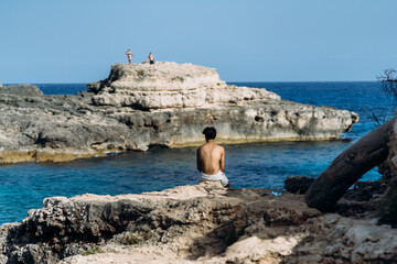 person sitting on the rocks