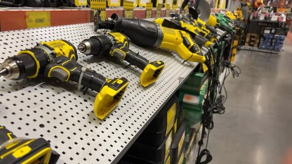Hand power tools - drills, grinders, screwdrivers, etc. lying on the shelf of the hardware store