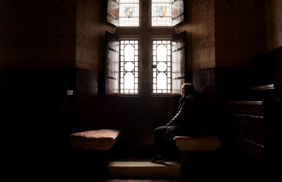 woman sat in the window of an English Heritage castle in Wales