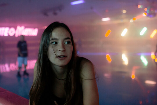Close up of girl on side of smokey roller rink