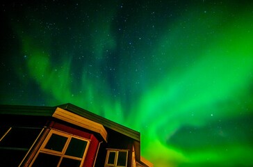 Icelandic Northern light above a red house