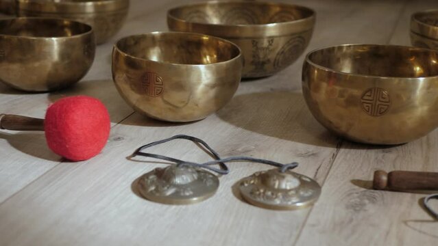 Tibetan singing bowls and mallet on the floor closeup