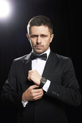 Man in black suite whit watch