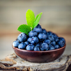 blueberries in a bowl on wooden table