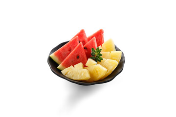 Slice of watermelon and pineapple in black plate isolated on white background.