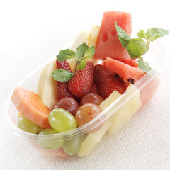 Mixed fruit in a  plastic bowl for delivery