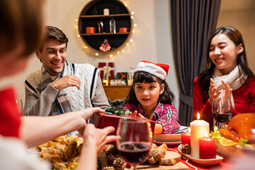 Multi-ethnic family exchanging presents during Christmas party at home