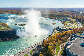 Overlooking the Niagara Falls Horseshoe Falls in a sunny day in autumn foliage season. Niagara...