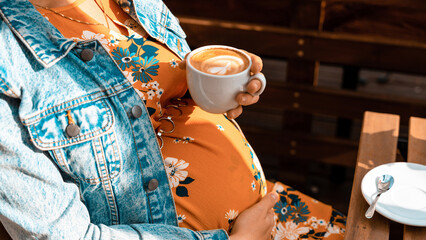 Pregnant woman drink coffee. Lifestyle morning with happy pregnancy girl drink espresso coffee....