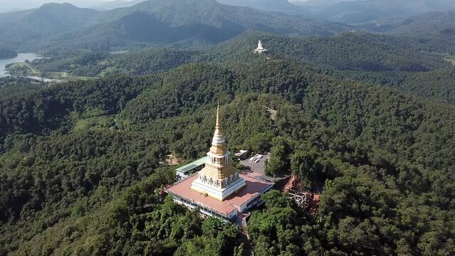 Aerial view of the large pagoda in Wat Phrathat Mon Phrachao Lai temple located on mountain elevation above seal level is 618 metres in Chiang Rai province, Thailand.