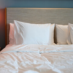 white bed and pillows in the room