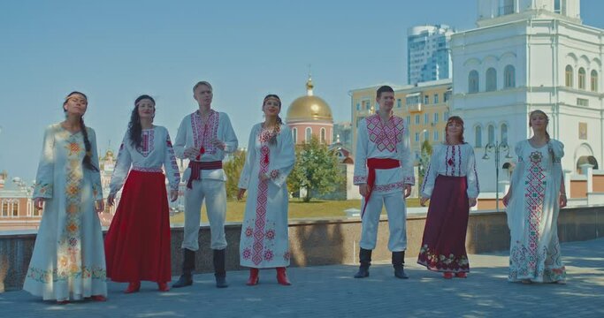 Ukrainians sing songs on the streets of the city, men and women in folk costumes smile and enjoy life. Happy Ukrainian people, friendship of people and nations. 4k, ProRes