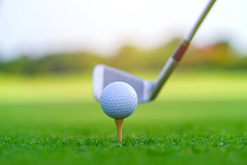 Golf ball on green grass ready to be struck on golf course