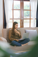 Working at home concept, Female freelance is touching hand on chest and talking in video call